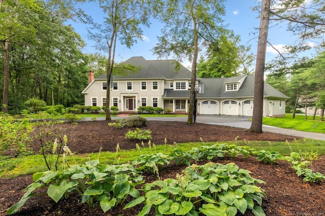 4 Brighton Ln, Simsbury, CT 06070 - view of front of home featuring concrete driveway and a chimney