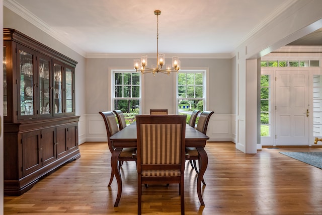 4 Brighton Ln, Simsbury, CT 06070 - dining room with a decorative wall, a chandelier, light wood-style flooring, ornamental molding, and wainscoting