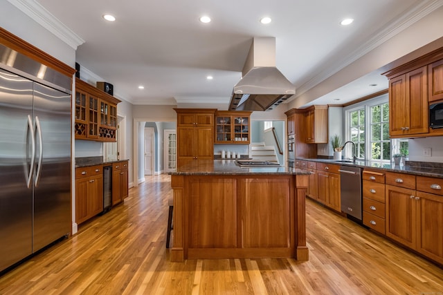 4 Brighton Ln, Simsbury, CT 06070 - kitchen featuring stainless steel appliances, island range hood, beverage cooler, brown cabinets, and light wood-style flooring