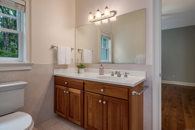 4 Brighton Ln, Simsbury, CT 06070 - bathroom featuring vanity, tile walls, wainscoting, and wood finished floors