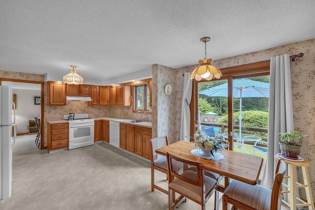 21 Briarcliffe Trl, Old Saybrook, CT 06475 - kitchen with white appliances, wallpapered walls, under cabinet range hood, a textured ceiling, and plenty of natural light