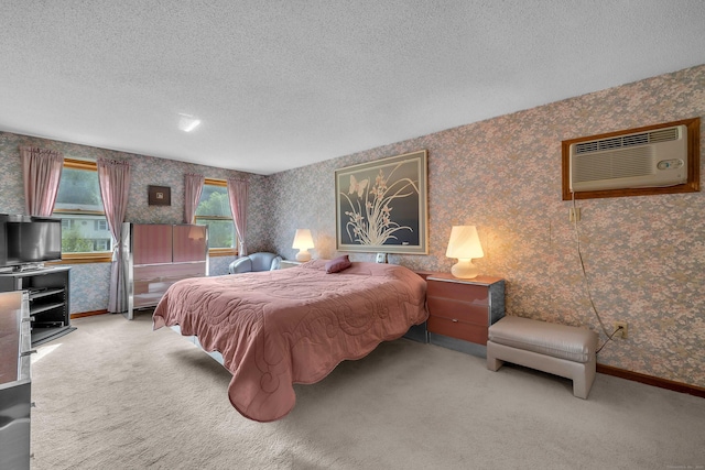 21 Briarcliffe Trl, Old Saybrook, CT 06475 - bedroom with wallpapered walls, a wall mounted air conditioner, a textured ceiling, and carpet flooring
