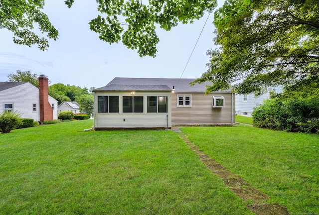 141 Orchard St, Meriden, CT 06450 - back of property with a yard, a sunroom, and roof with shingles