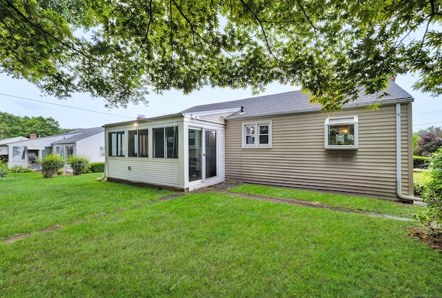 141 Orchard St, Meriden, CT 06450 - rear view of property featuring a lawn, a sunroom, and roof with shingles
