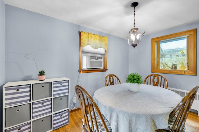 141 Orchard St, Meriden, CT 06450 - dining area with wood finished floors, cooling unit, and a chandelier