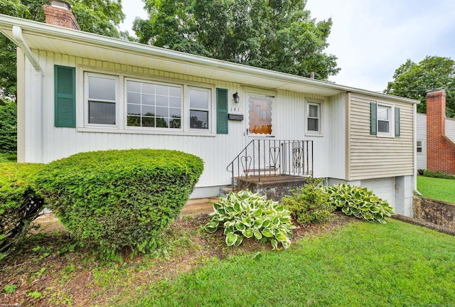 141 Orchard St, Meriden, CT 06450 - view of front of home with a chimney, a garage, and a front yard