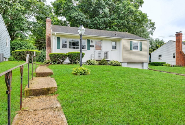 141 Orchard St, Meriden, CT 06450 - view of front of house featuring a chimney, a front yard, and roof with shingles