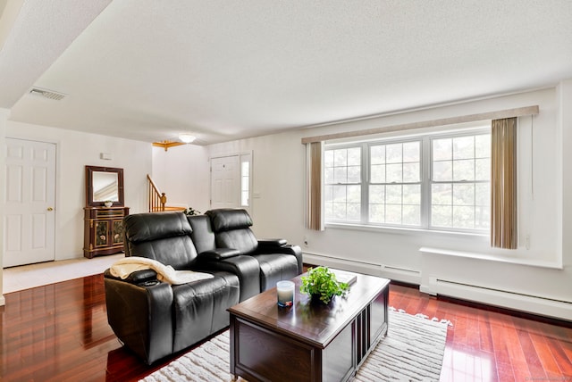 120 Plank Hill Rd, Simsbury, CT 06070 - living room featuring stairs, a baseboard heating unit, a baseboard radiator, hardwood / wood-style flooring, and a textured ceiling