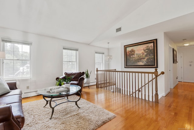 120 Plank Hill Rd, Simsbury, CT 06070 - living area featuring light wood-type flooring, healthy amount of natural light, lofted ceiling, a baseboard heating unit, and a baseboard radiator