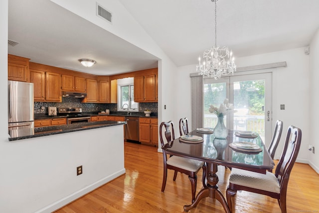 120 Plank Hill Rd, Simsbury, CT 06070 - kitchen featuring stainless steel appliances, under cabinet range hood, light wood finished floors, backsplash, and a chandelier