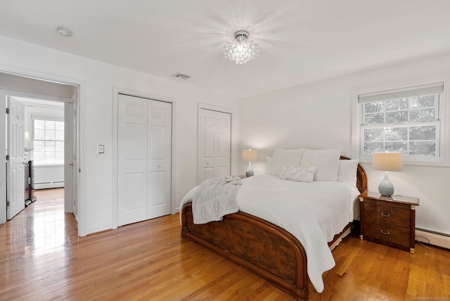 120 Plank Hill Rd, Simsbury, CT 06070 - bedroom featuring multiple closets, multiple windows, a baseboard radiator, and light wood finished floors