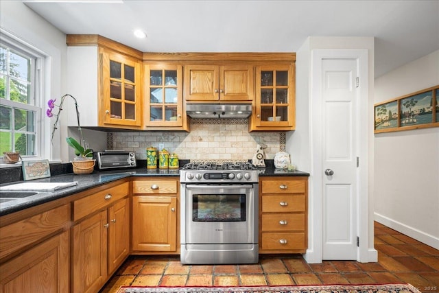 25 Spring St, Chester, CT 06412 - kitchen with gas range, under cabinet range hood, tasteful backsplash, brown cabinets, and recessed lighting