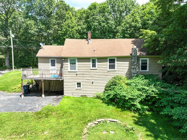 183 Schroback Rd, Plymouth, CT 06782 - back of house with a deck, a yard, a patio area, a chimney, and a shingled roof