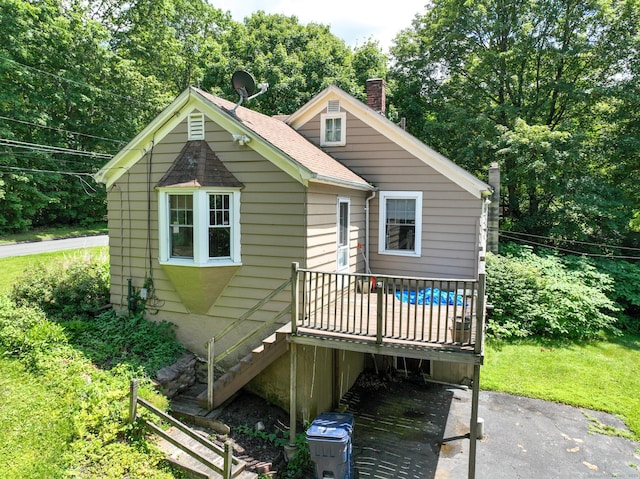 183 Schroback Rd, Plymouth, CT 06782 - bungalow featuring a chimney, a deck, stairway, roof with shingles, and a patio