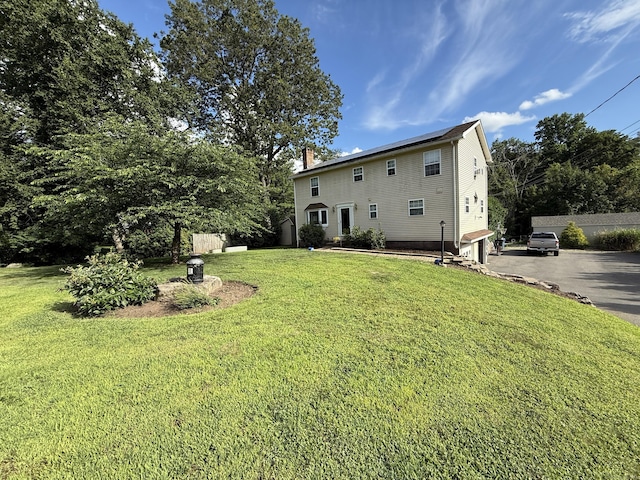 7 School St, Burlington, CT 06013 - rear view of property featuring a yard, driveway, and a chimney