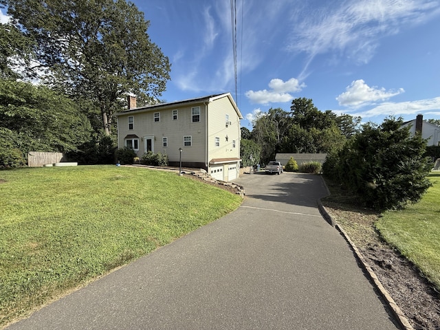7 School St, Burlington, CT 06013 - view of front of property with a garage, a chimney, asphalt driveway, and a front lawn
