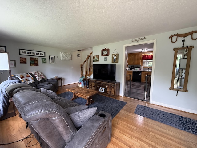 7 School St, Burlington, CT 06013 - living room featuring a textured ceiling, stairs, and light wood-type flooring