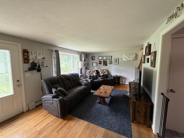 7 School St, Burlington, CT 06013 - living area with a baseboard heating unit, a textured ceiling, and light wood-style flooring