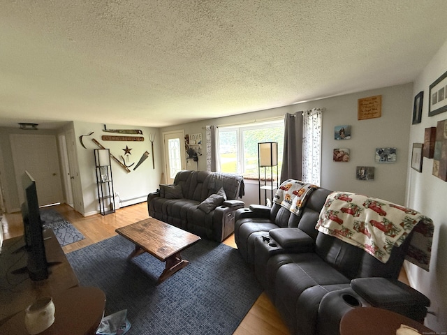 7 School St, Burlington, CT 06013 - living area featuring a textured ceiling, light wood-style floors, and baseboard heating