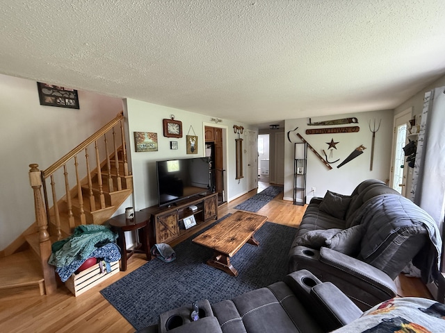 7 School St, Burlington, CT 06013 - living area with a textured ceiling, wood finished floors, and stairway