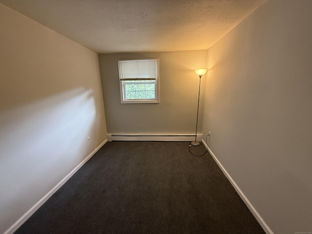 7 School St, Burlington, CT 06013 - spare room with a baseboard heating unit, a textured ceiling, and dark carpet