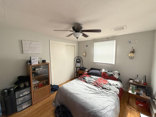 7 School St, Burlington, CT 06013 - bedroom with light wood-style floors, a closet, a textured ceiling, and ceiling fan