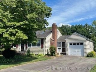 4 Allen St, Portland, CT 06480 - view of front of house featuring an attached garage, asphalt driveway, and a chimney