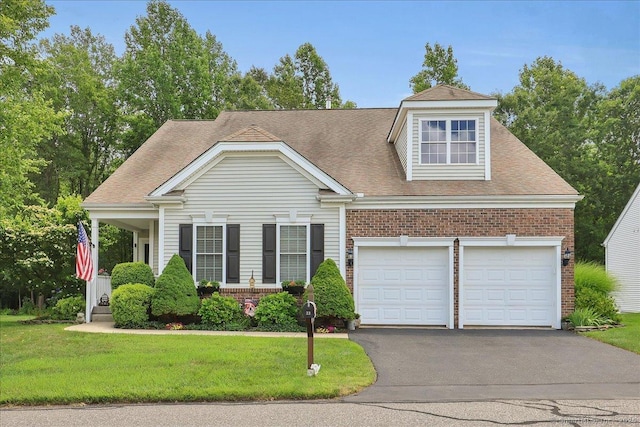 33 Wadsworth Ln Unit 33, Wallingford, CT 06492 - view of front of property with brick siding, asphalt driveway, a front yard, and a garage