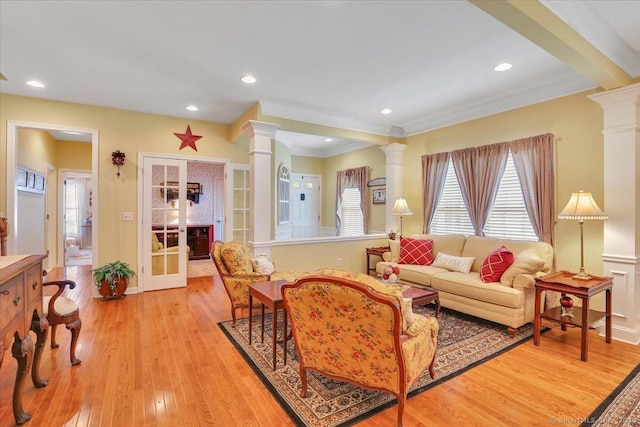 33 Wadsworth Ln Unit 33, Wallingford, CT 06492 - living room featuring decorative columns, light wood-style flooring, crown molding, and recessed lighting