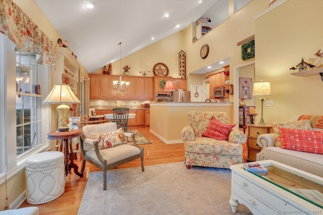 33 Wadsworth Ln Unit 33, Wallingford, CT 06492 - living room featuring a chandelier, light wood-type flooring, and high vaulted ceiling