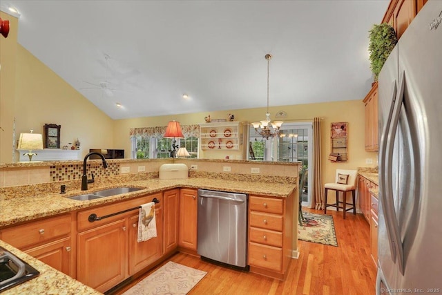 33 Wadsworth Ln Unit 33, Wallingford, CT 06492 - kitchen featuring stainless steel appliances, vaulted ceiling, a chandelier, light wood-style floors, and light stone countertops