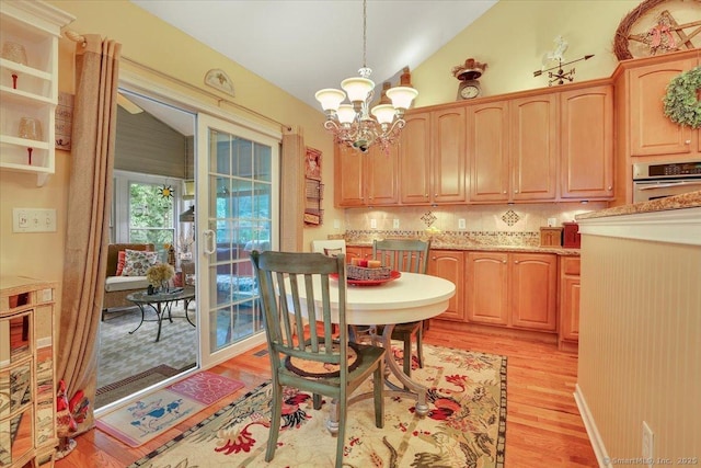 33 Wadsworth Ln Unit 33, Wallingford, CT 06492 - dining space with light wood-style flooring, lofted ceiling, and a chandelier