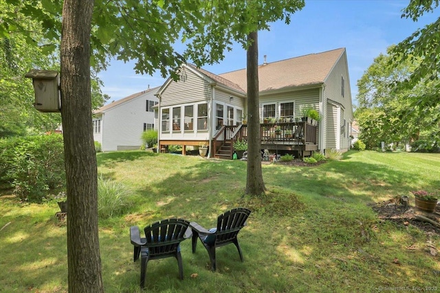 33 Wadsworth Ln Unit 33, Wallingford, CT 06492 - rear view of property with a sunroom, a wooden deck, a lawn, and roof with shingles