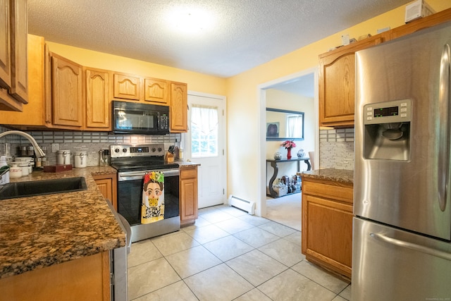 82 Pleasant St, Thomaston, CT 06787 - kitchen featuring appliances with stainless steel finishes, baseboard heating, tasteful backsplash, a textured ceiling, and light tile patterned floors