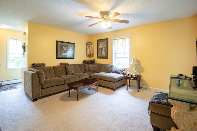 82 Pleasant St, Thomaston, CT 06787 - living room featuring baseboard heating, light colored carpet, and ceiling fan