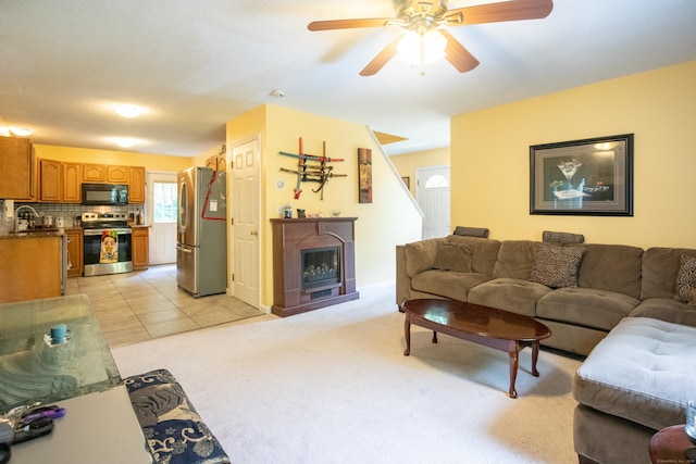 82 Pleasant St, Thomaston, CT 06787 - living room with a fireplace, ceiling fan, and light carpet