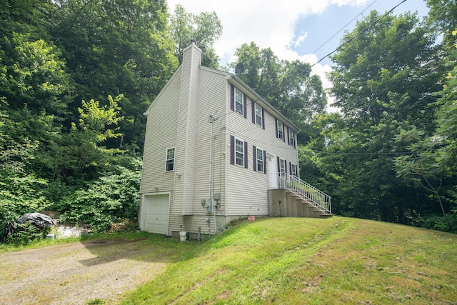 82 Pleasant St, Thomaston, CT 06787 - view of side of property with a chimney, a lawn, a garage, and driveway