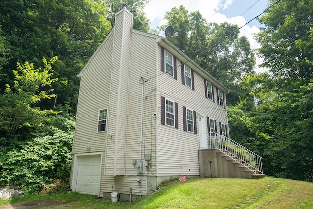 82 Pleasant St, Thomaston, CT 06787 - view of home's exterior with a chimney, a lawn, and a garage