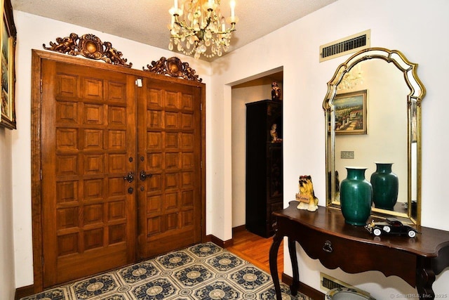 400 Williams Rd, Wallingford, CT 06492 - foyer featuring a chandelier, wood finished floors, and a textured ceiling