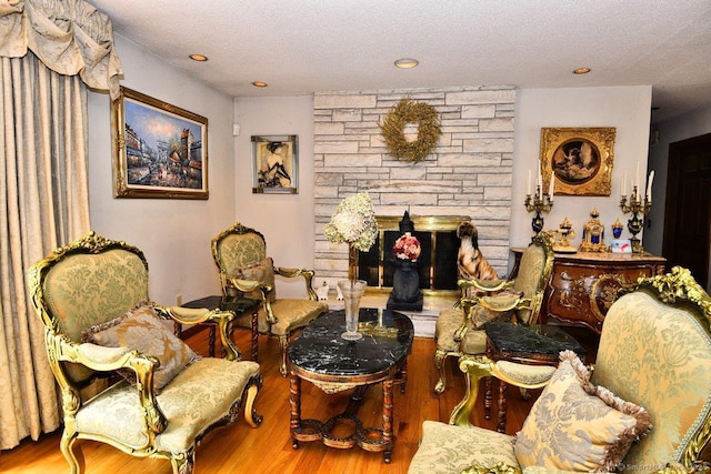 400 Williams Rd, Wallingford, CT 06492 - living area with wood finished floors, a textured ceiling, recessed lighting, and a stone fireplace