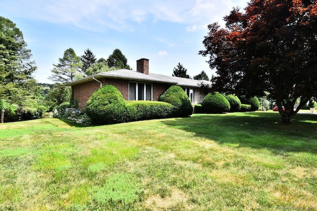 400 Williams Rd, Wallingford, CT 06492 - view of side of property featuring a chimney, a lawn, and brick siding