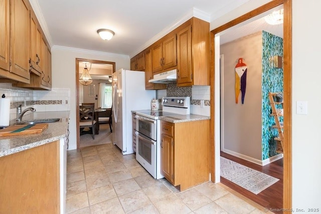 40 Orchard Brook Dr Unit 40, Wethersfield, CT 06109 - kitchen featuring white appliances, under cabinet range hood, light countertops, tasteful backsplash, and ornamental molding