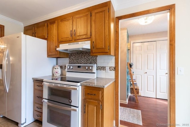40 Orchard Brook Dr Unit 40, Wethersfield, CT 06109 - kitchen with white appliances, under cabinet range hood, backsplash, brown cabinetry, and light wood-style floors