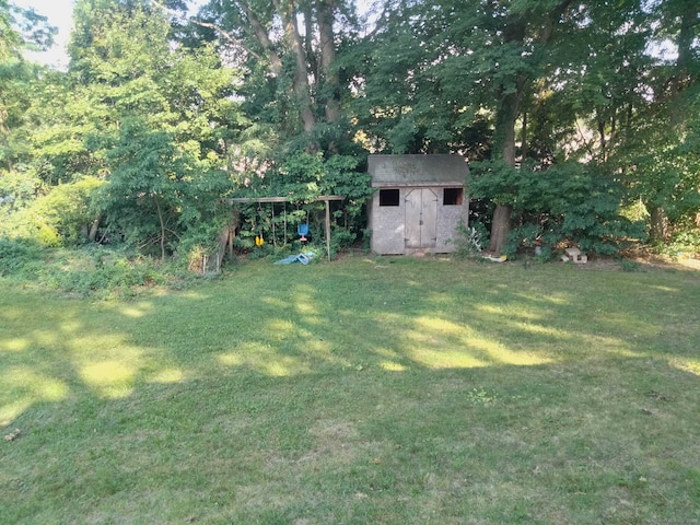 142 S Center St, Windsor Locks, CT 06096 - view of green lawn with a storage shed and a detached carport