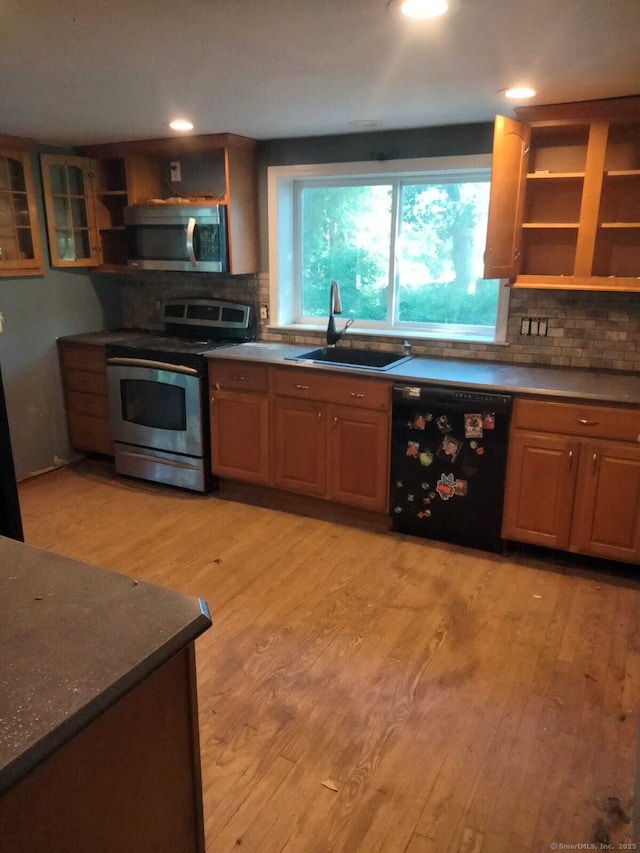 142 S Center St, Windsor Locks, CT 06096 - kitchen with appliances with stainless steel finishes, open shelves, tasteful backsplash, light wood-type flooring, and recessed lighting