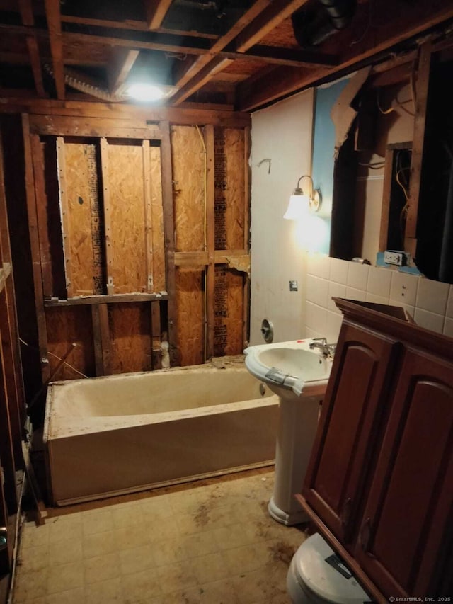 142 S Center St, Windsor Locks, CT 06096 - bathroom with a tub and tile patterned floors