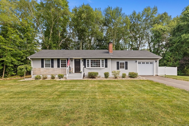 24 Wapping Wood Rd, Ellington, CT 06029 - ranch-style house with an attached garage, asphalt driveway, a chimney, and view of wooded area