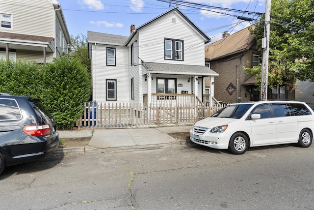 237 Helen St, Bridgeport, CT 06608 - view of front of property with a fenced front yard, a porch, a chimney, and roof with shingles