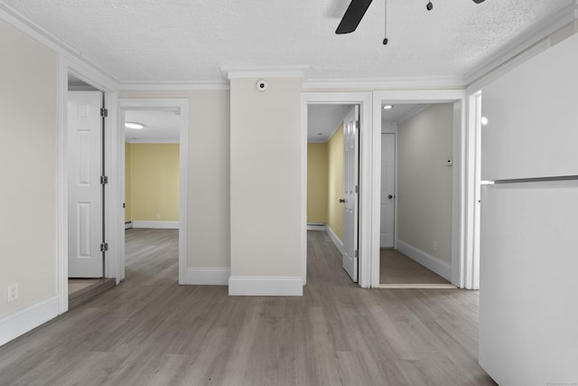 237 Helen St, Bridgeport, CT 06608 - empty room featuring a ceiling fan, wood finished floors, a textured ceiling, crown molding, and a baseboard heating unit
