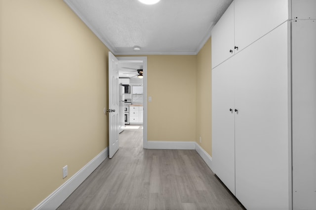 237 Helen St, Bridgeport, CT 06608 - corridor with light wood-style floors, a textured ceiling, and crown molding